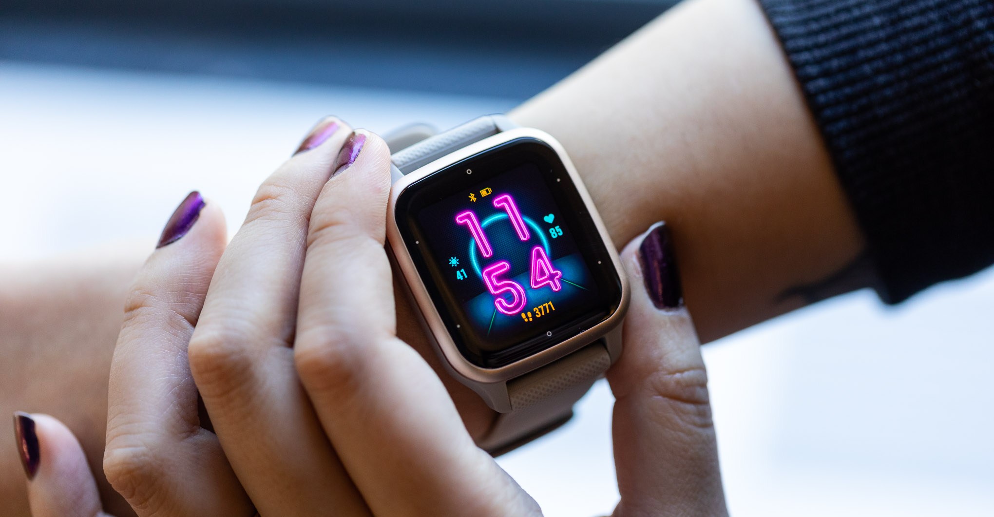 Garmin Venu Sq 2 showing bright clock face on woman’s wrist
