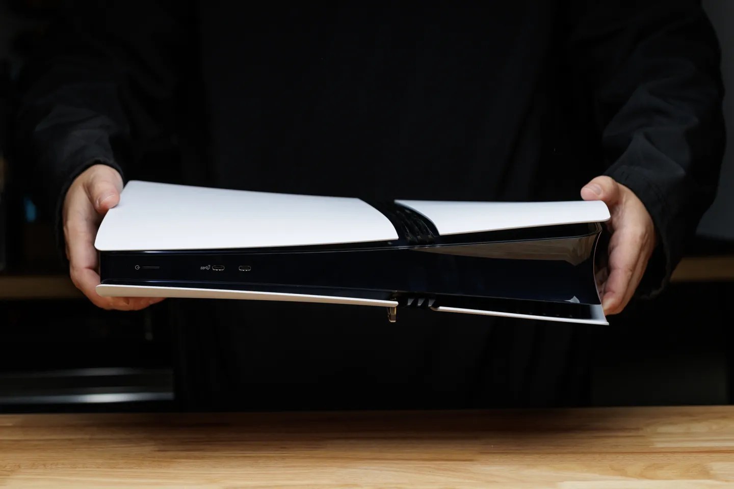 An image of a person holding a PS5 Pro.