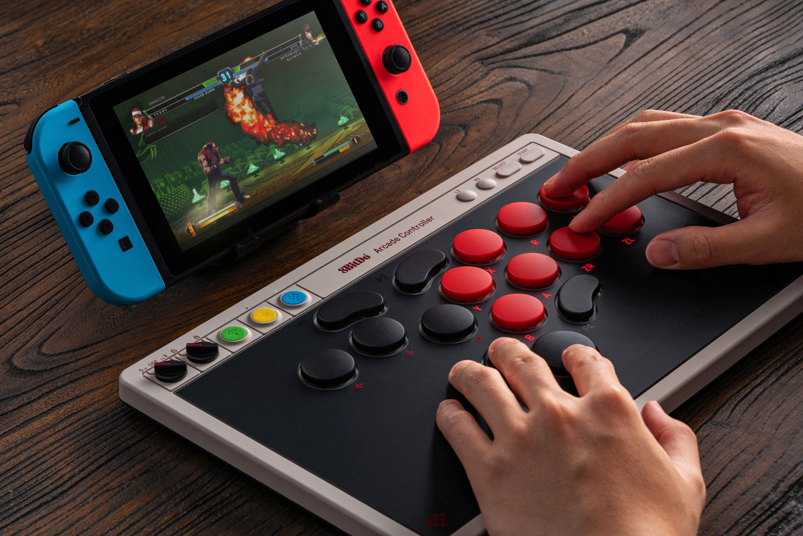 A person playing the 8BitDo Arcade Controller with a Nintendo Switch.