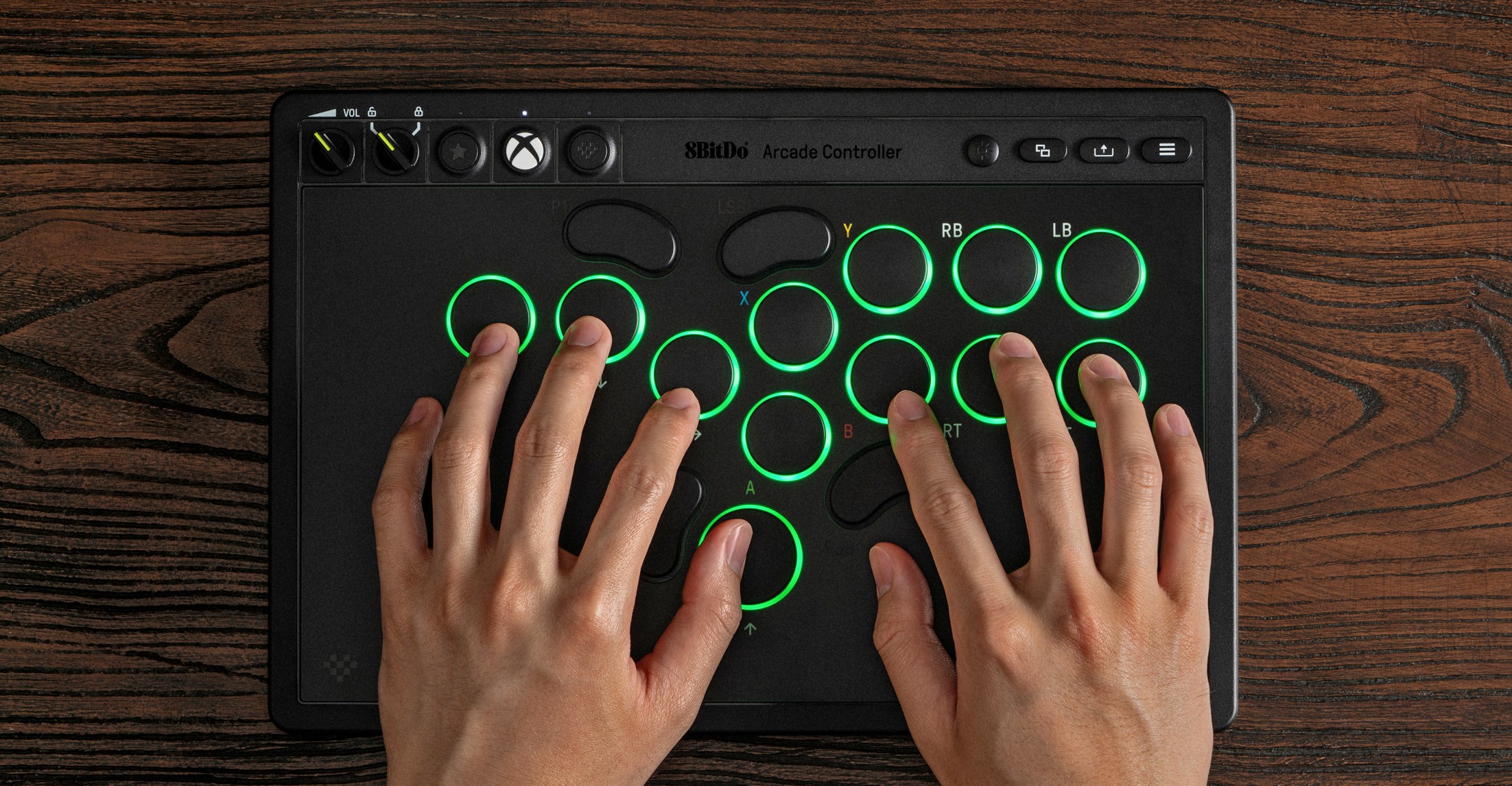 Two hands using the Xbox version of 8BitDo’s leverless Arcade Controller.