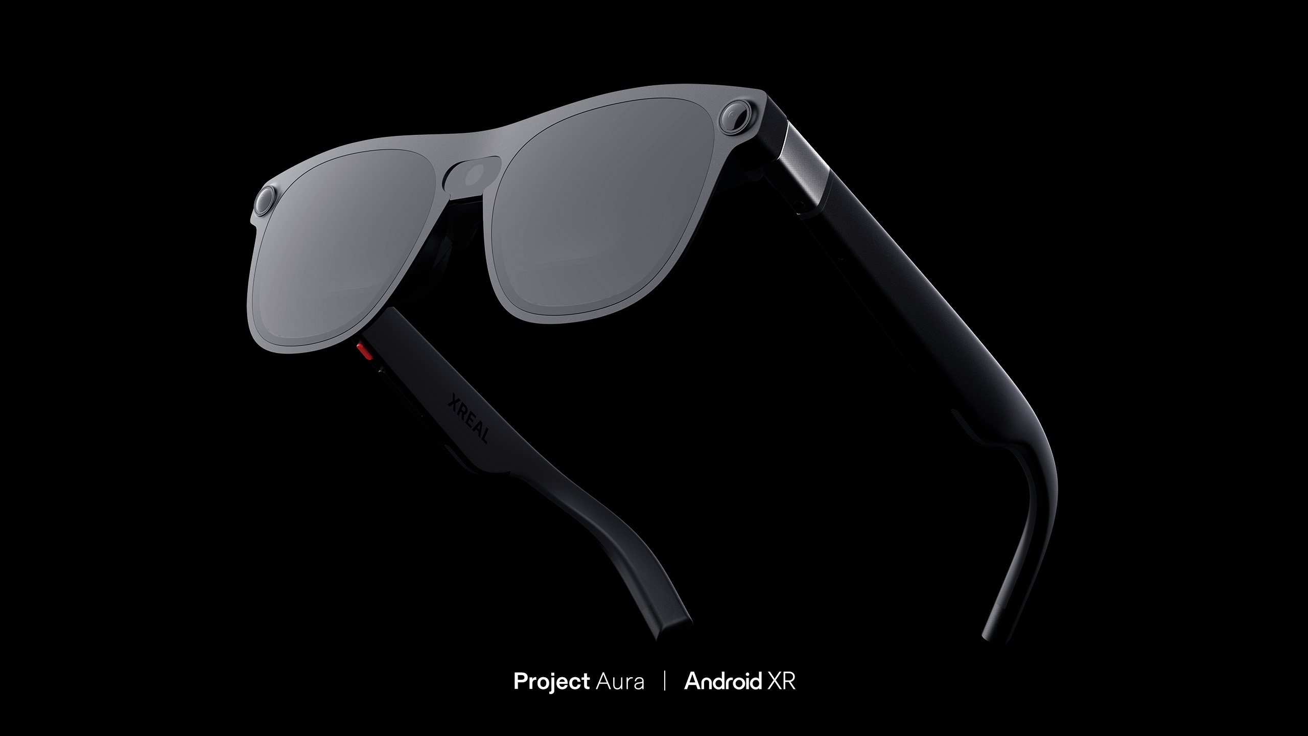Render of a pair of sunglasses with a camera in the hinge. The words Project Aura and Android XR at at the bottom.