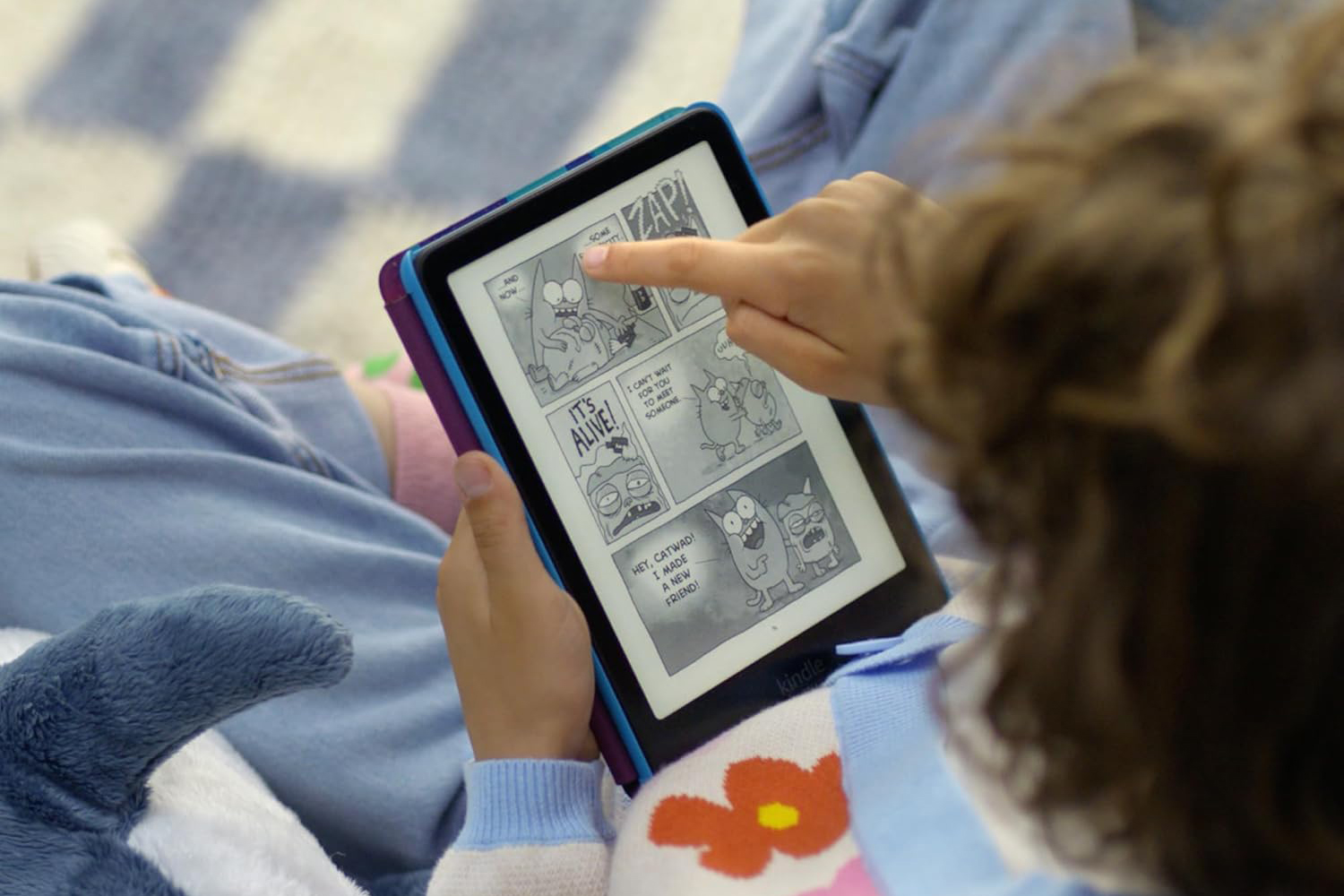 A person reading a comic on the Kindle Paperwhite Kids.