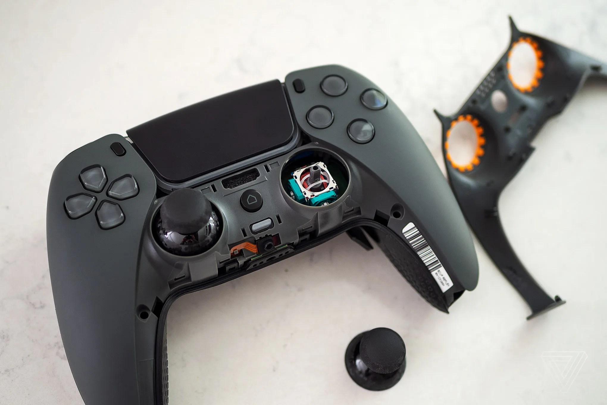 A Scuf Reflex Pro controller with its right stick topper popped off.