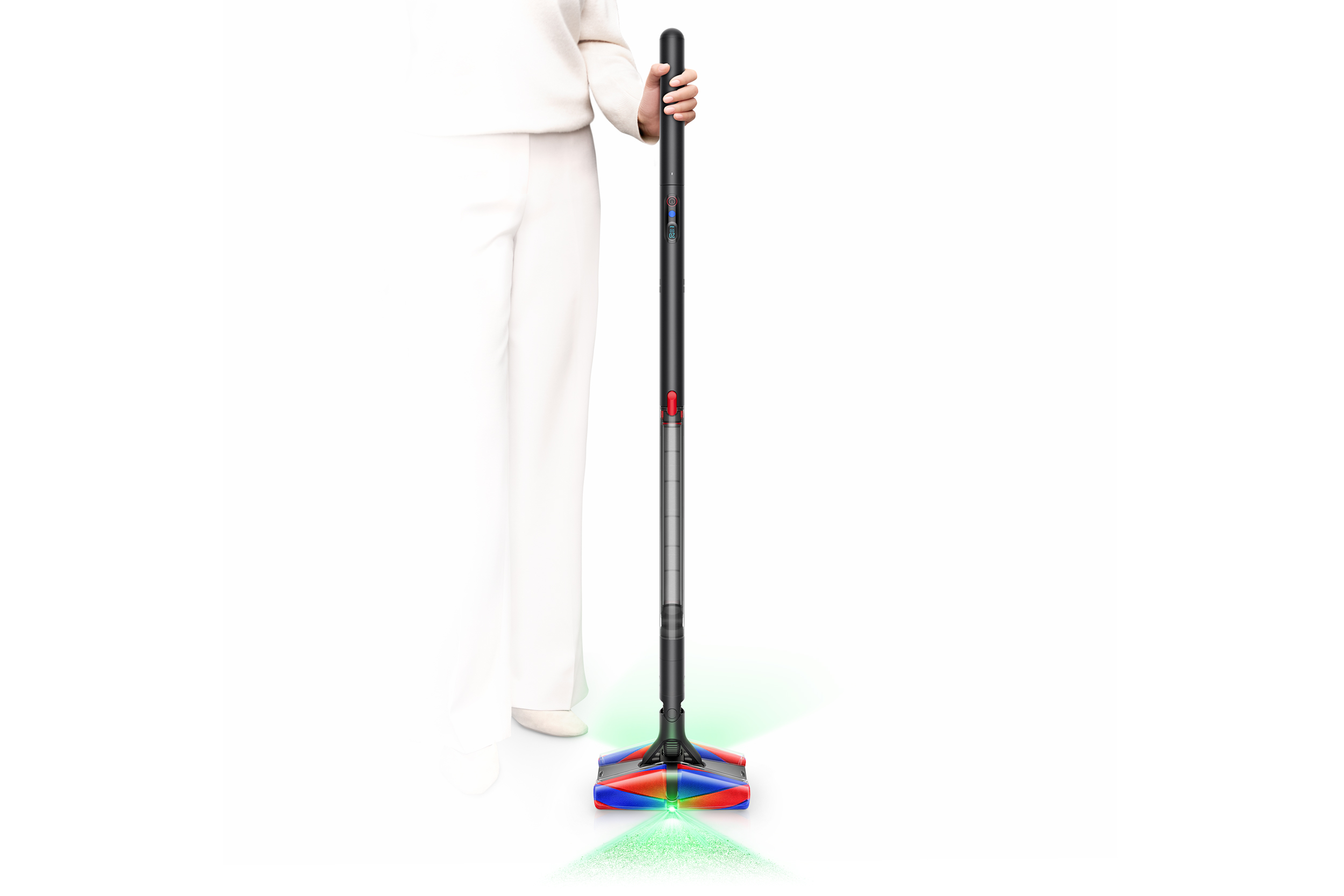 A person holding and standing next to the Dyson PencilVac against a white background.