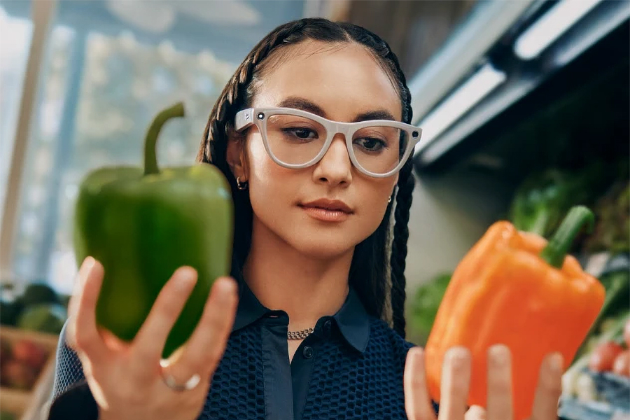 A person wearing Ray-Ban Meta smart glasses looking at two peppers.