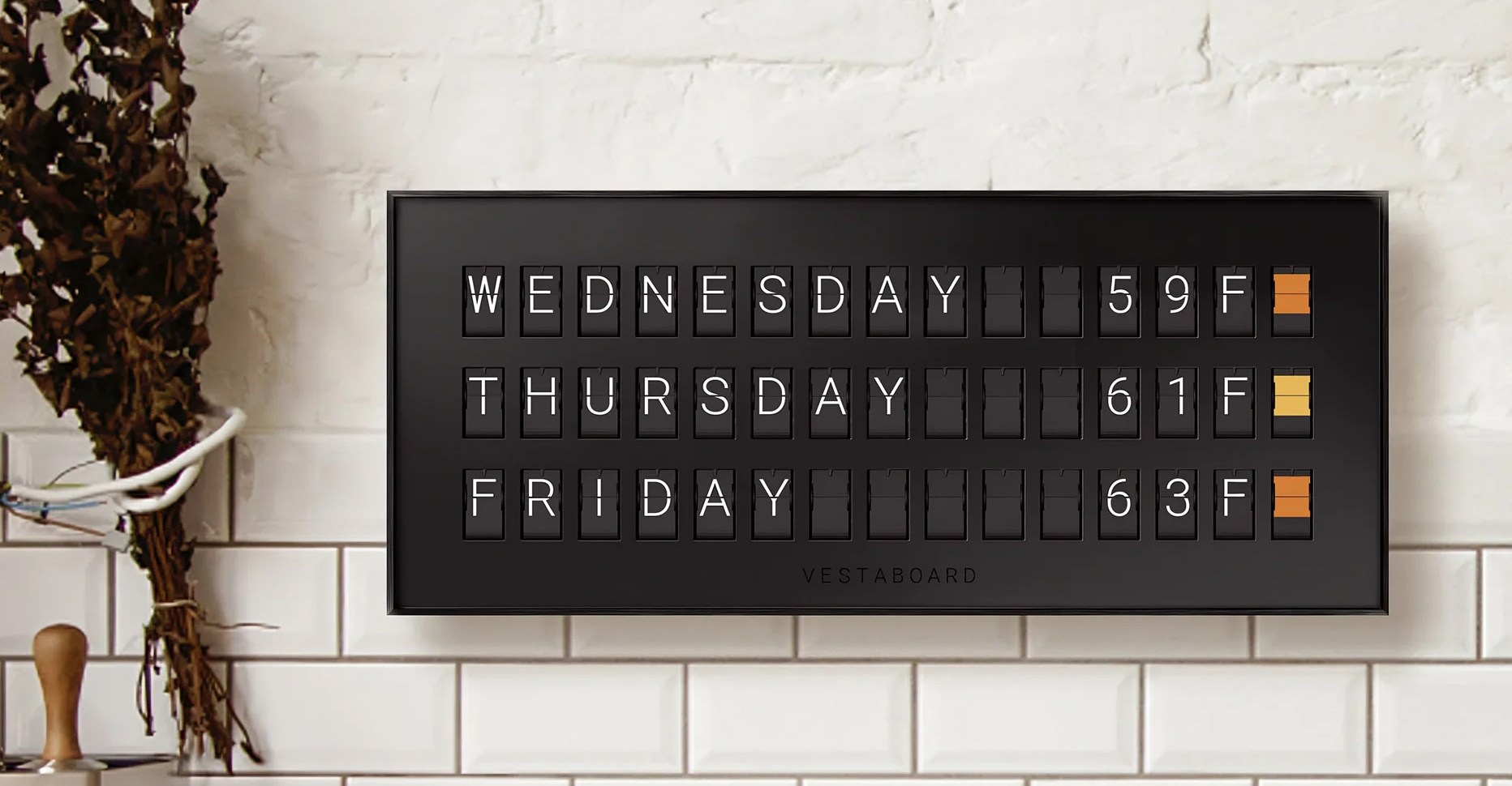 The Vestaboard Note on the wall of a kitchen showing a forecast for three days of the week.