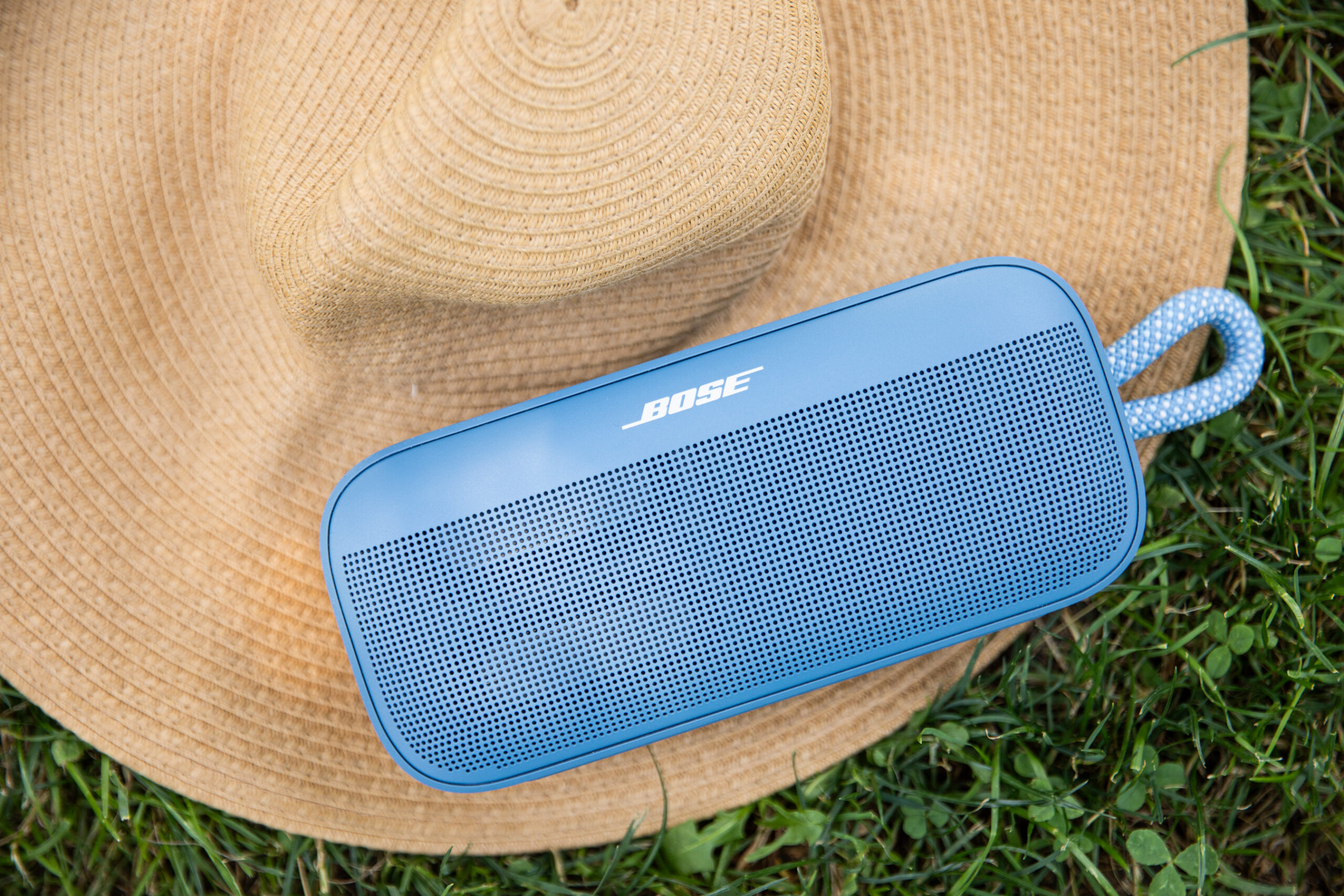 A blue Bose speaker on a hat.