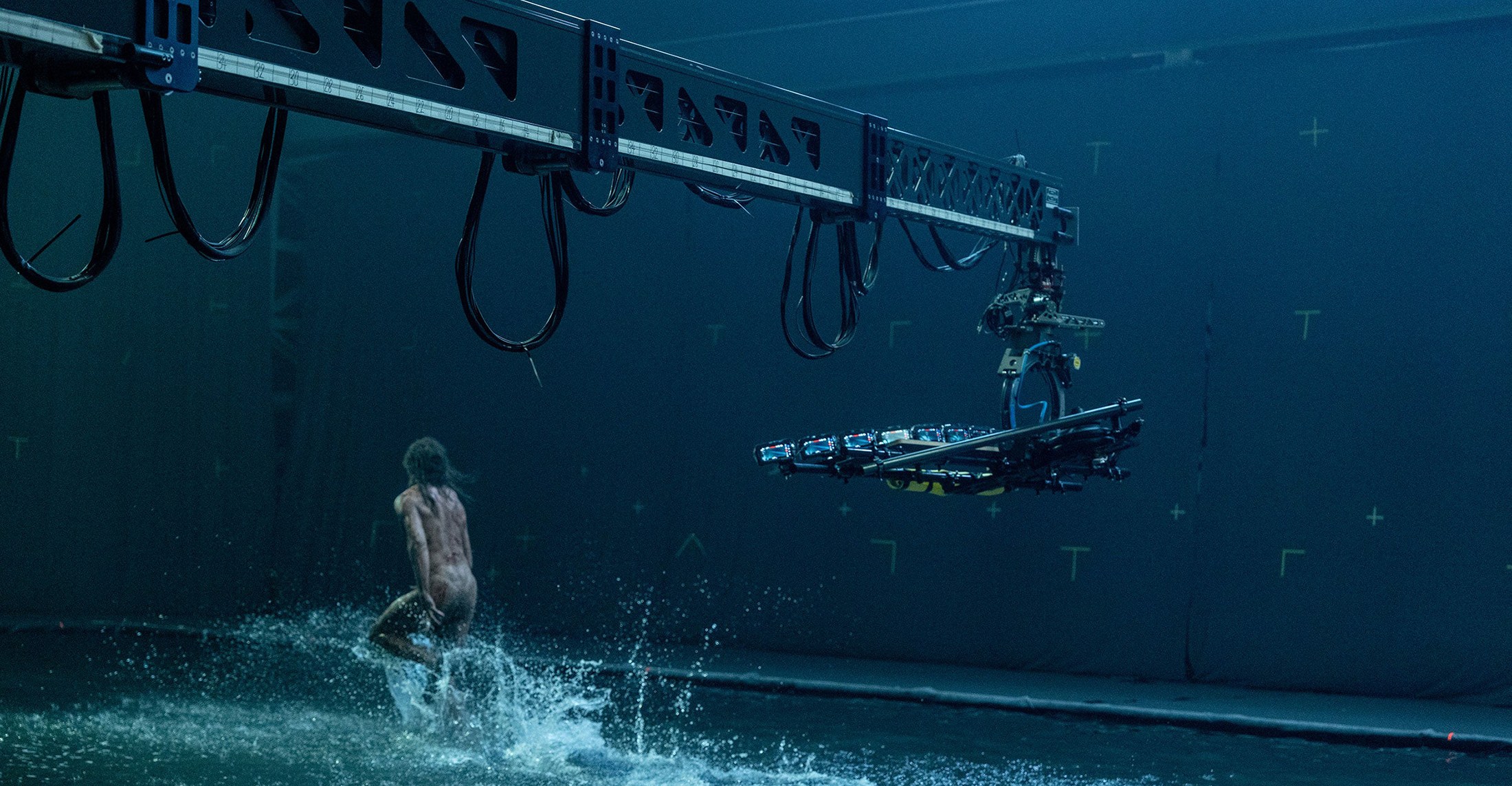 A naked man running through water filmed by a crane-mounted iPhone rig for 28 Years Later.
