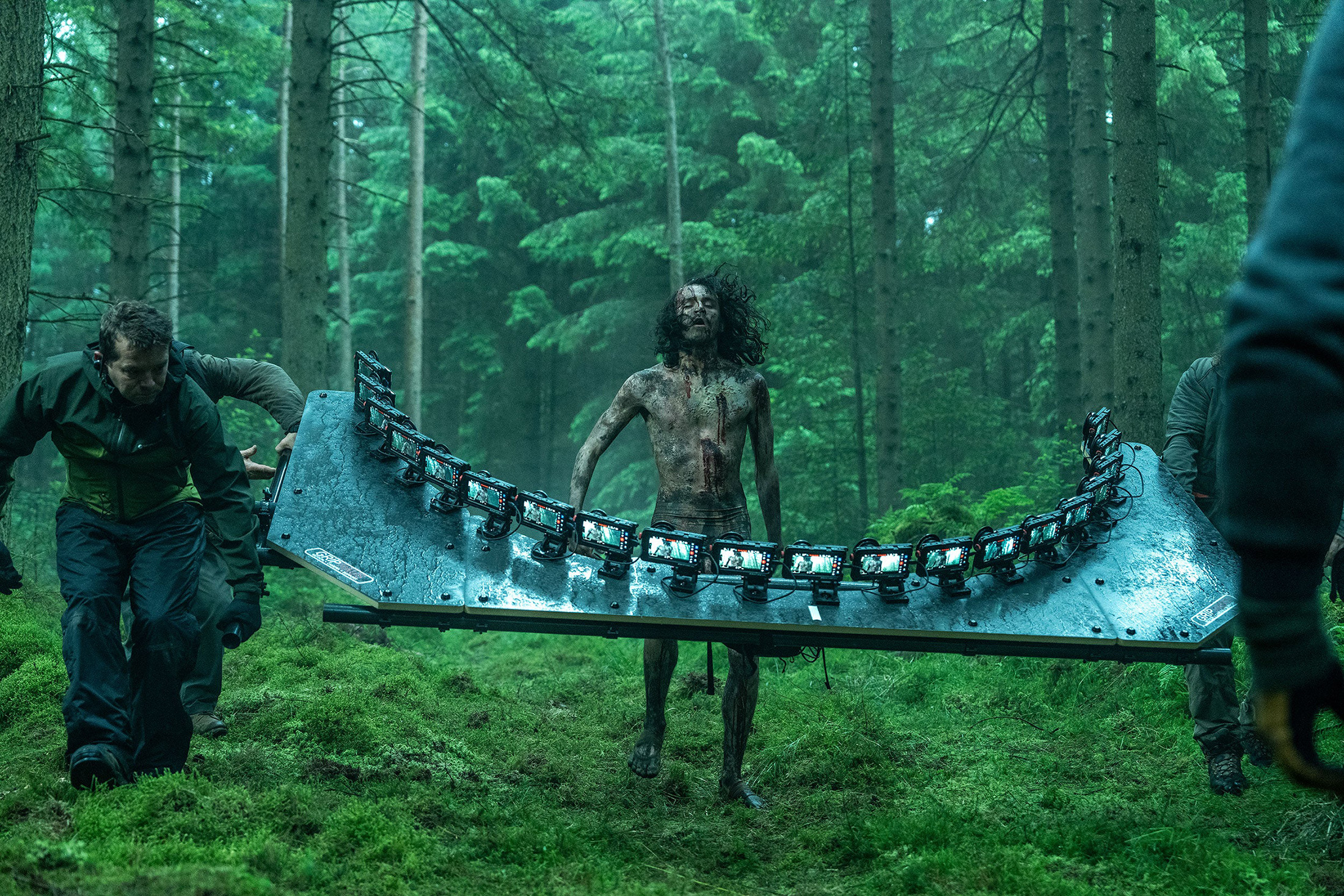 An infected man in a forest being filmed on 20 iPhones for 28 Years Later.