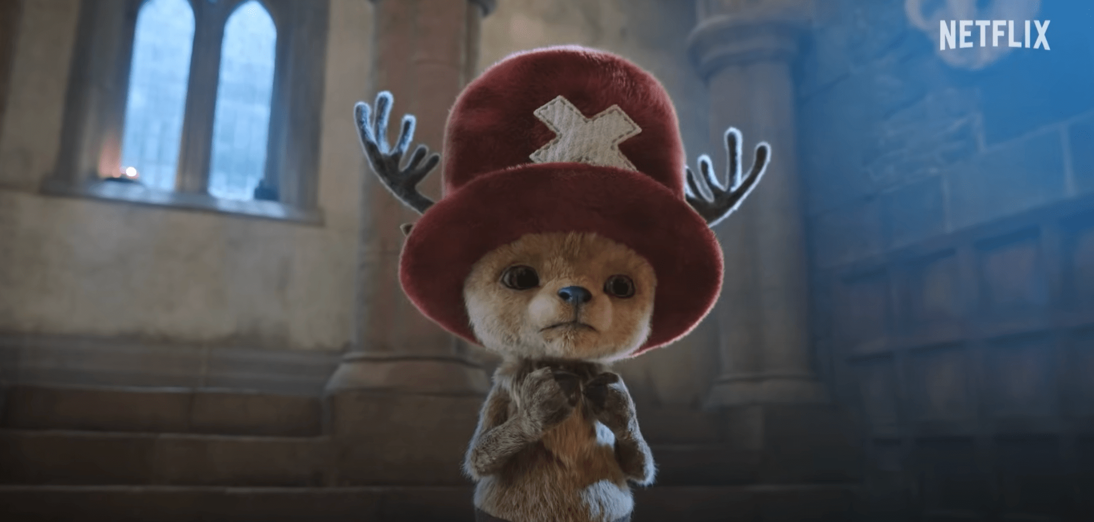 A photo of a woman placed next to an image of an anthropomorphic reindeer wearing a fuzzy red hat.