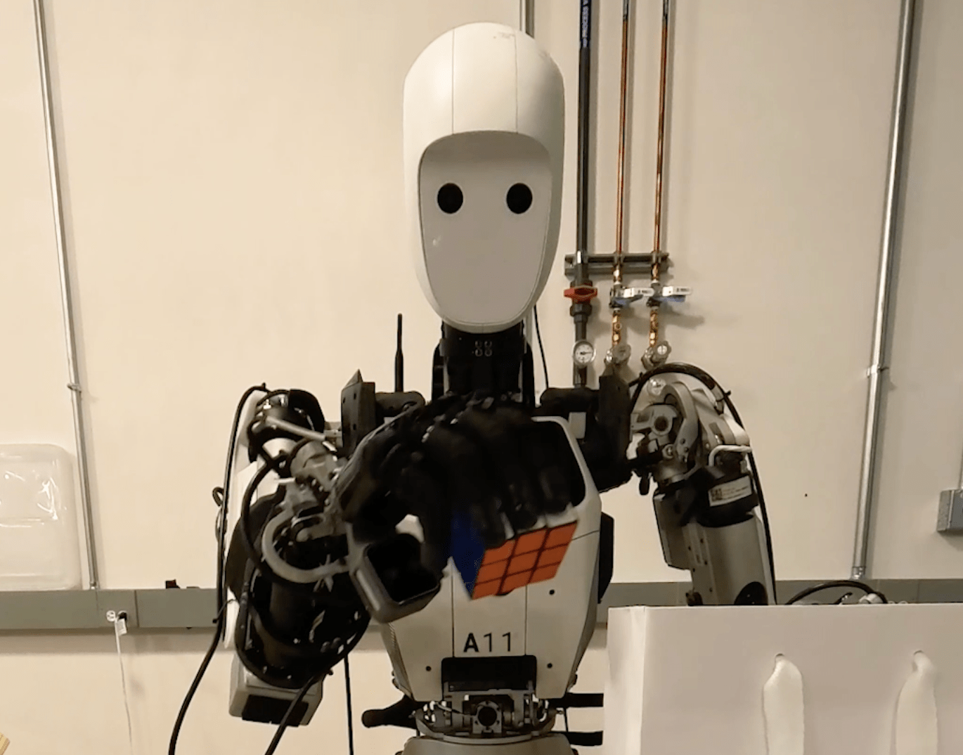 An image of an Apptronik robot putting a Rubik’s Cube in a bag.
