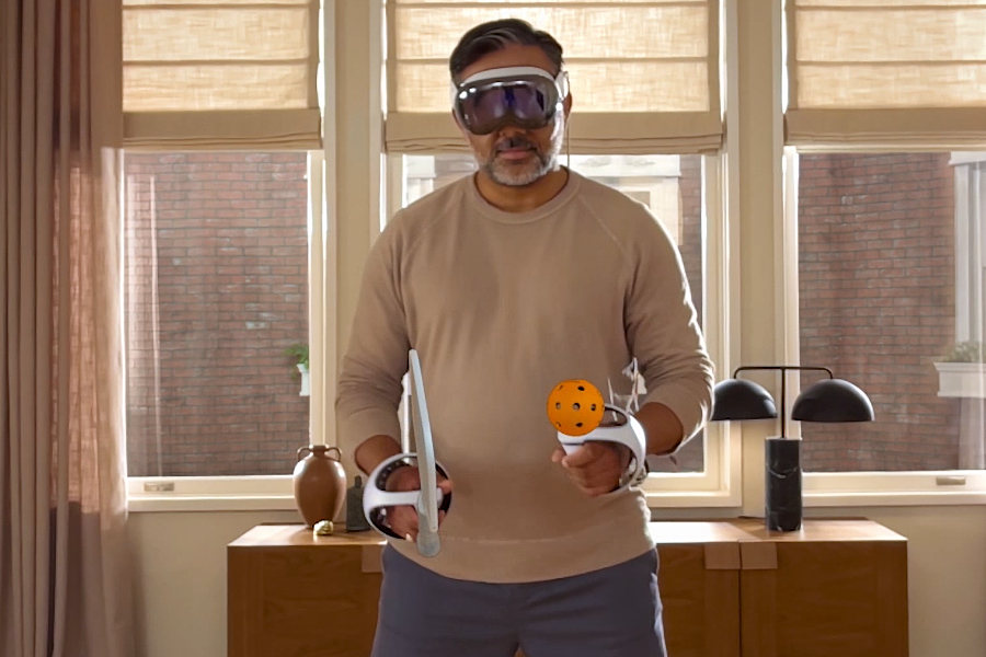 A person wearing the Apple Vision Pro headset while playing a VR game.