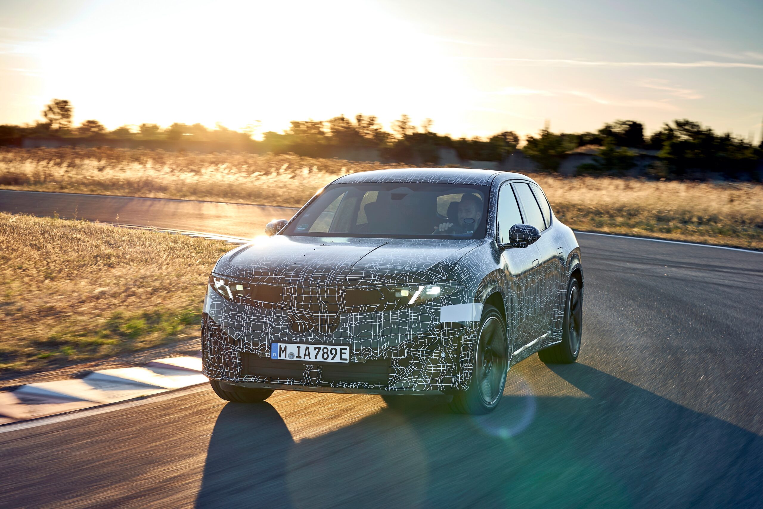 photo of BMW iX3 prototype on a track.