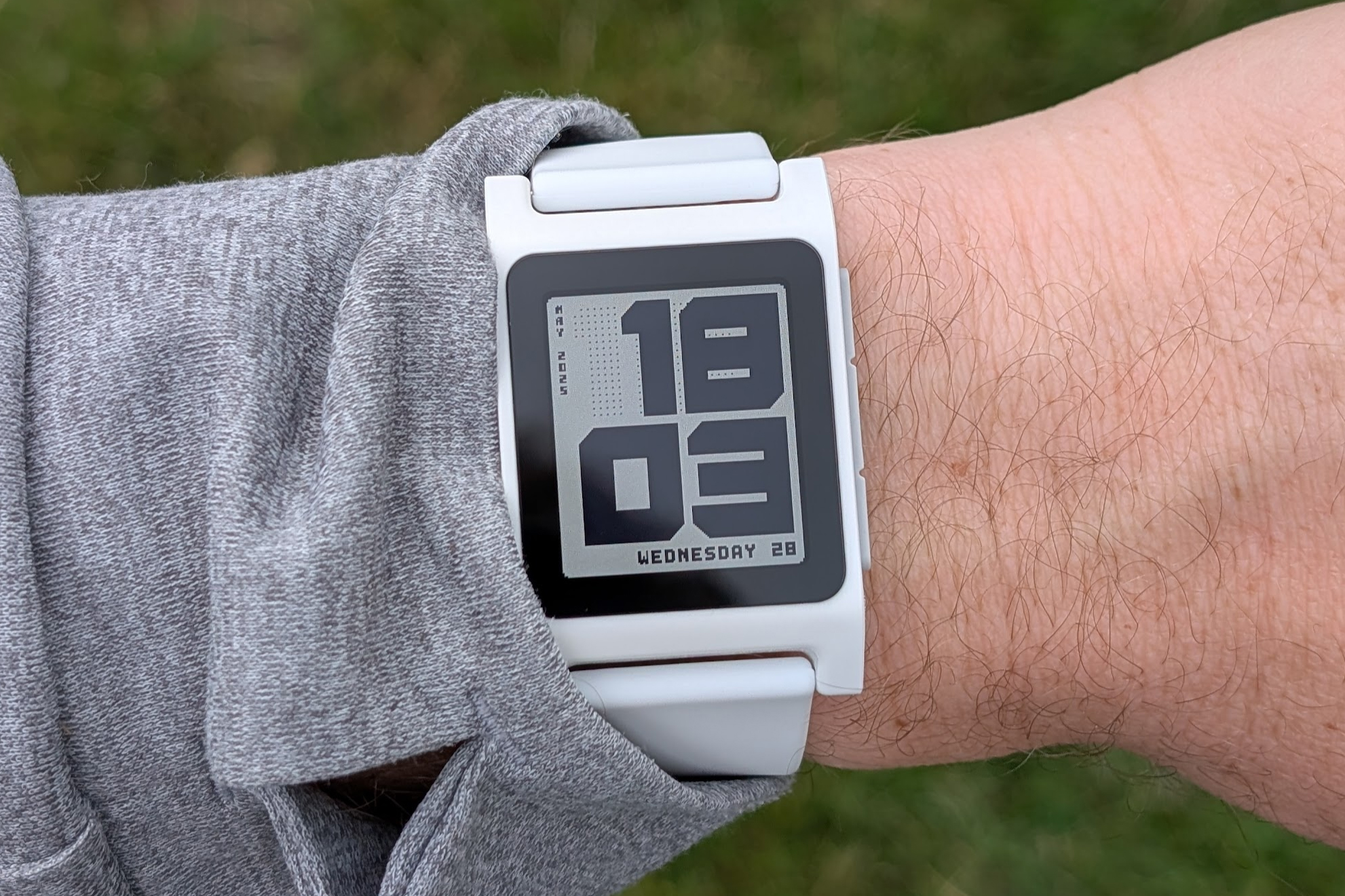 A close-up of a Core 2 Duo smartwatch strapped to someone’s wrist.