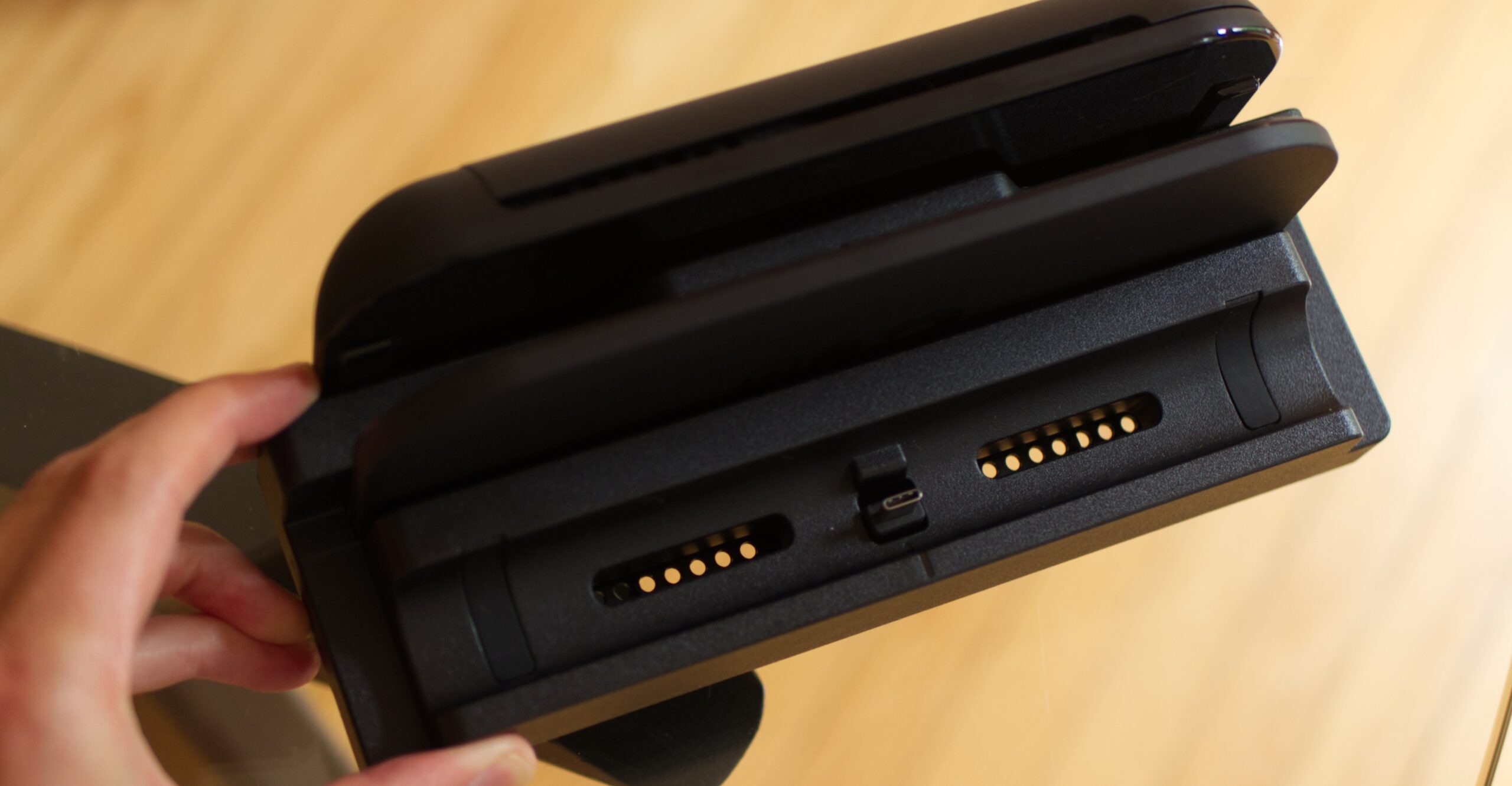 A top-down image taken of the Nintendo Switch 2 dock with Dbrand's Killswitch USB-C dock adapter attached to it.