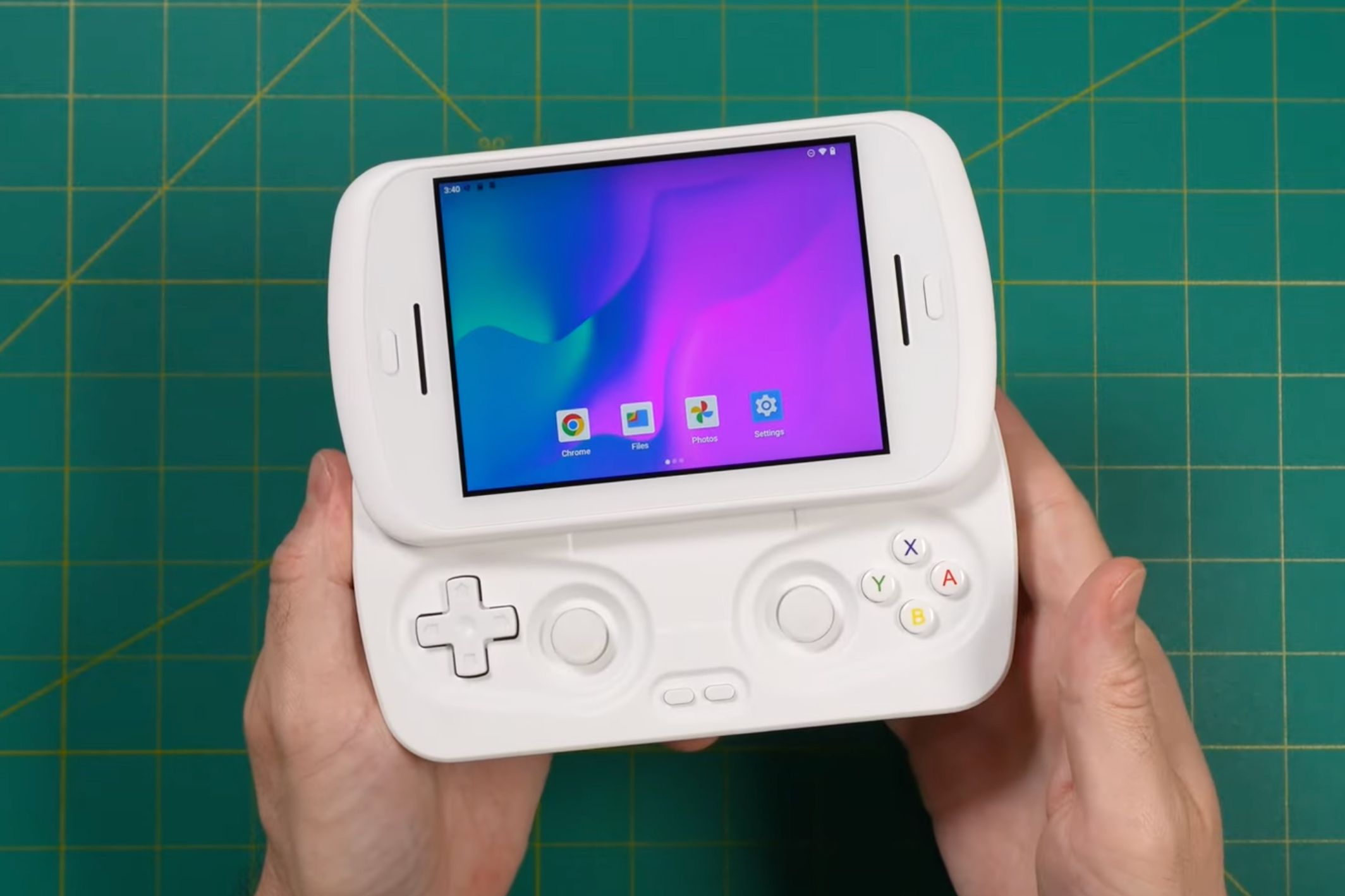 A person holding the Anbernic RG Slide with its controls revealed.