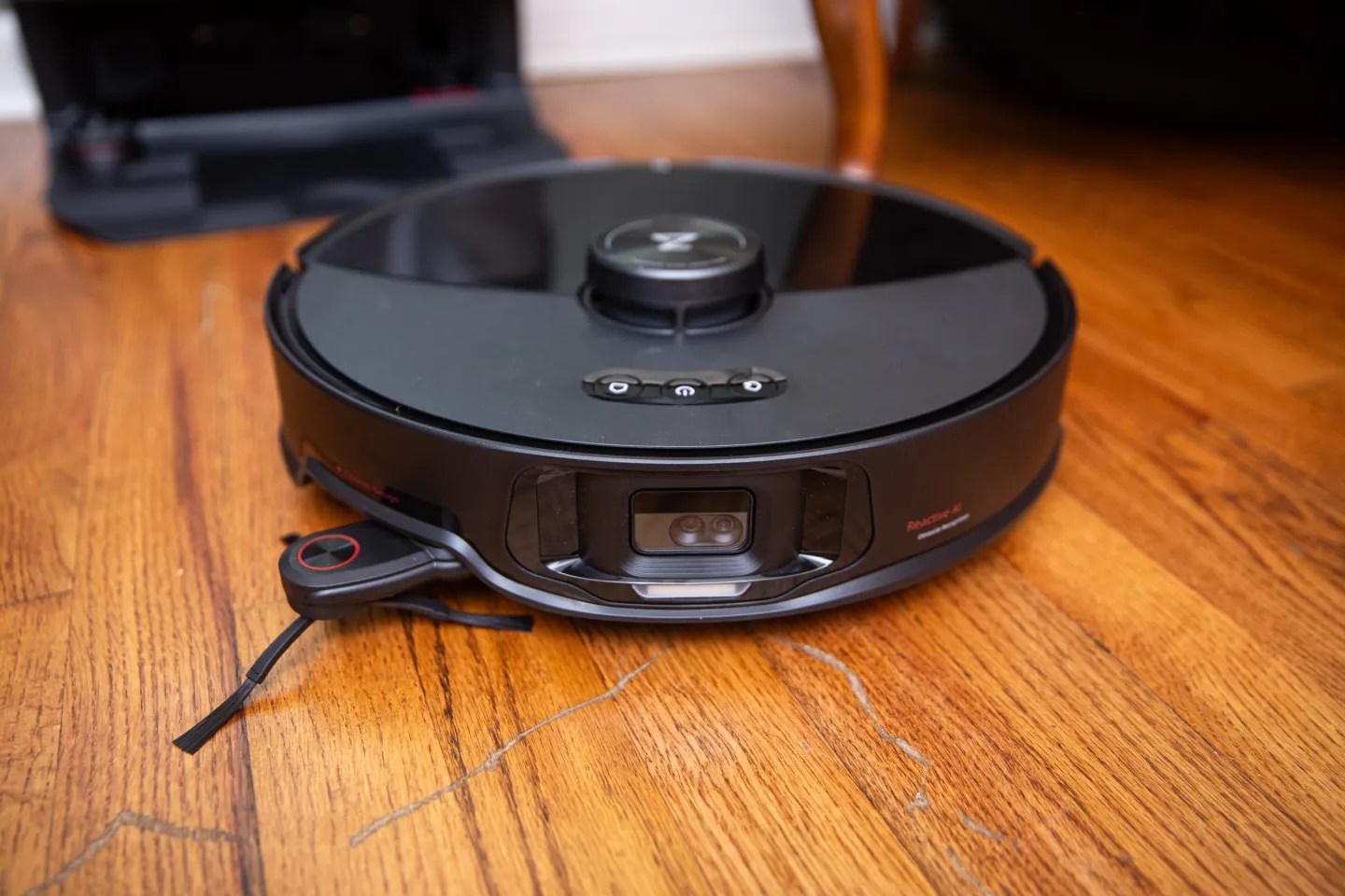 The front of the Roborock S8 Max Ultra as it rests on a hardwood floor.