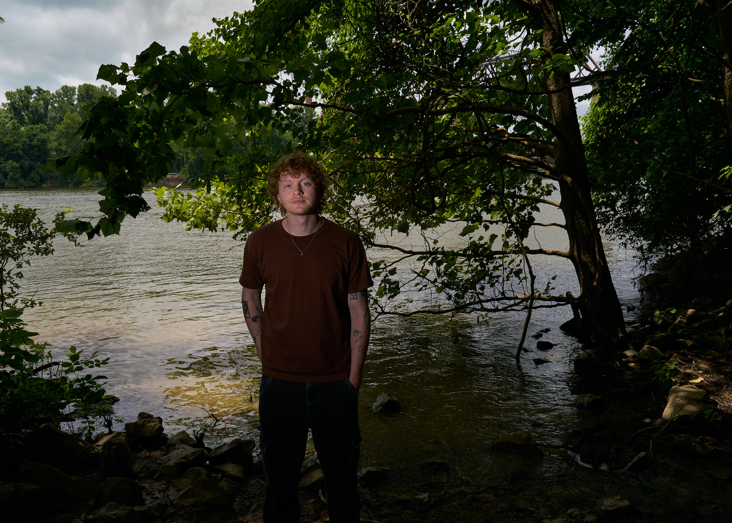 Musician Knox Morris pictured in front of a lake at Shelby Park in Nashville, Tennessee