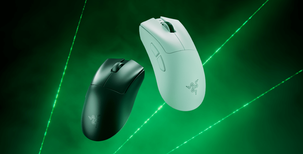 Two Razer DeathAdder V4 Pro wireless mice, one black and one white, against a green laser background.