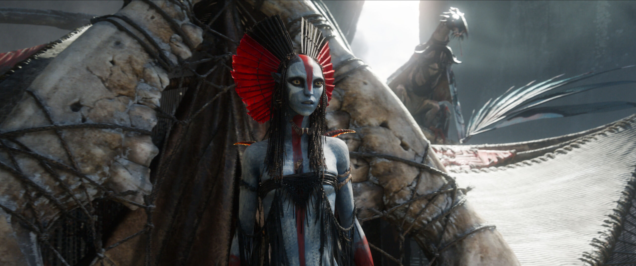 A blue humanoid alien wearing a black and red headdress.
