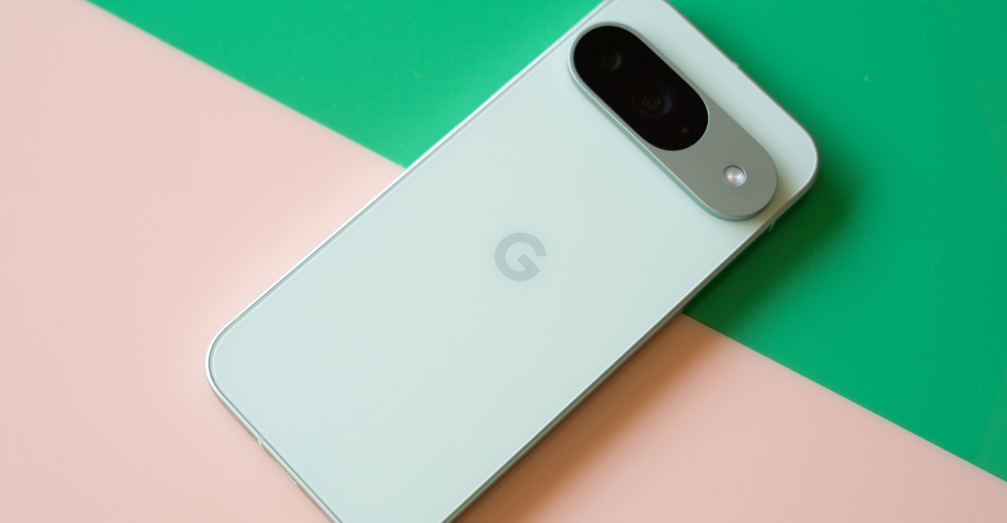 Google Pixel 9 on a pink and green background.