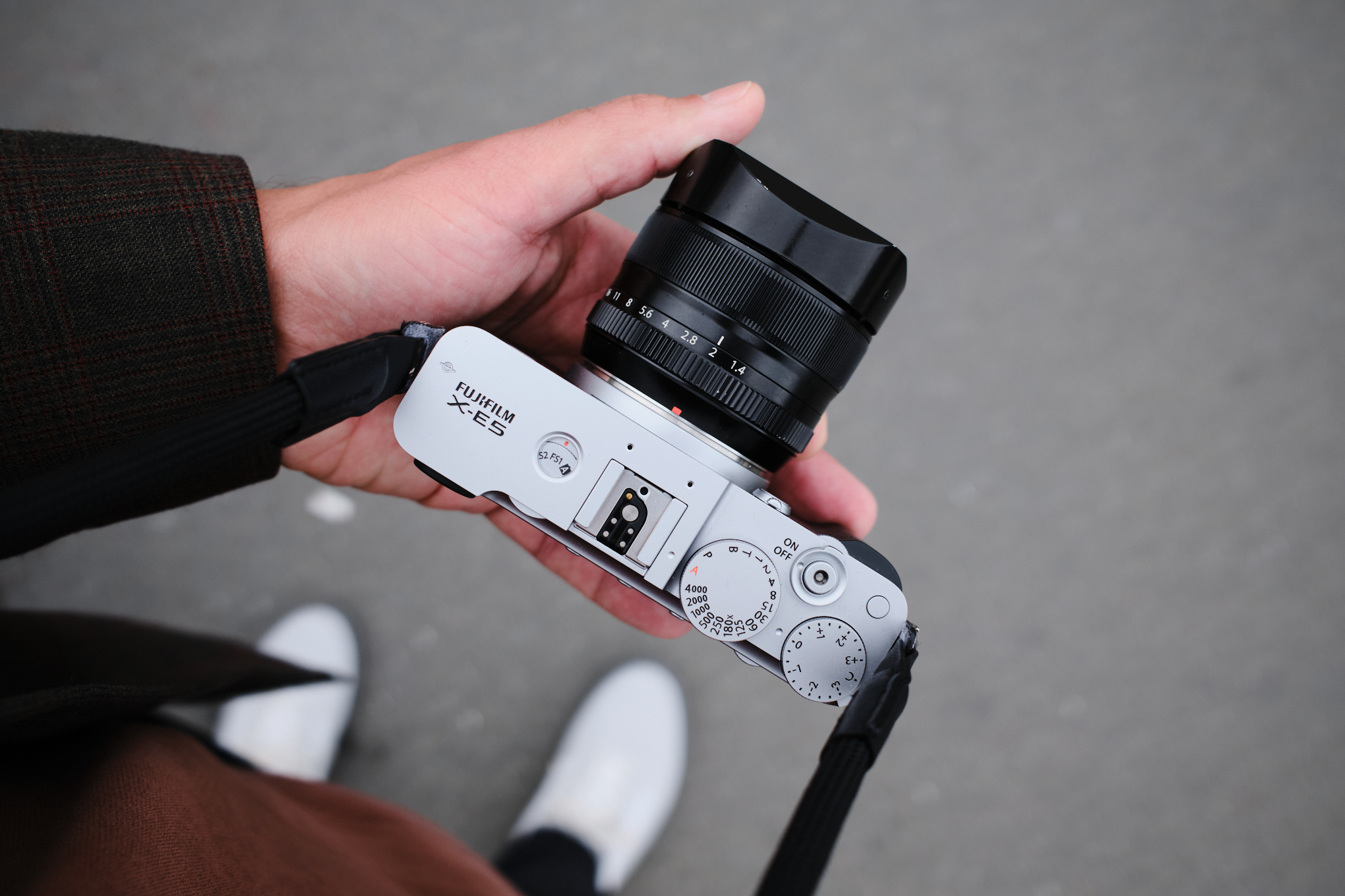Hands holding the Fujifilm X-e5 camera.