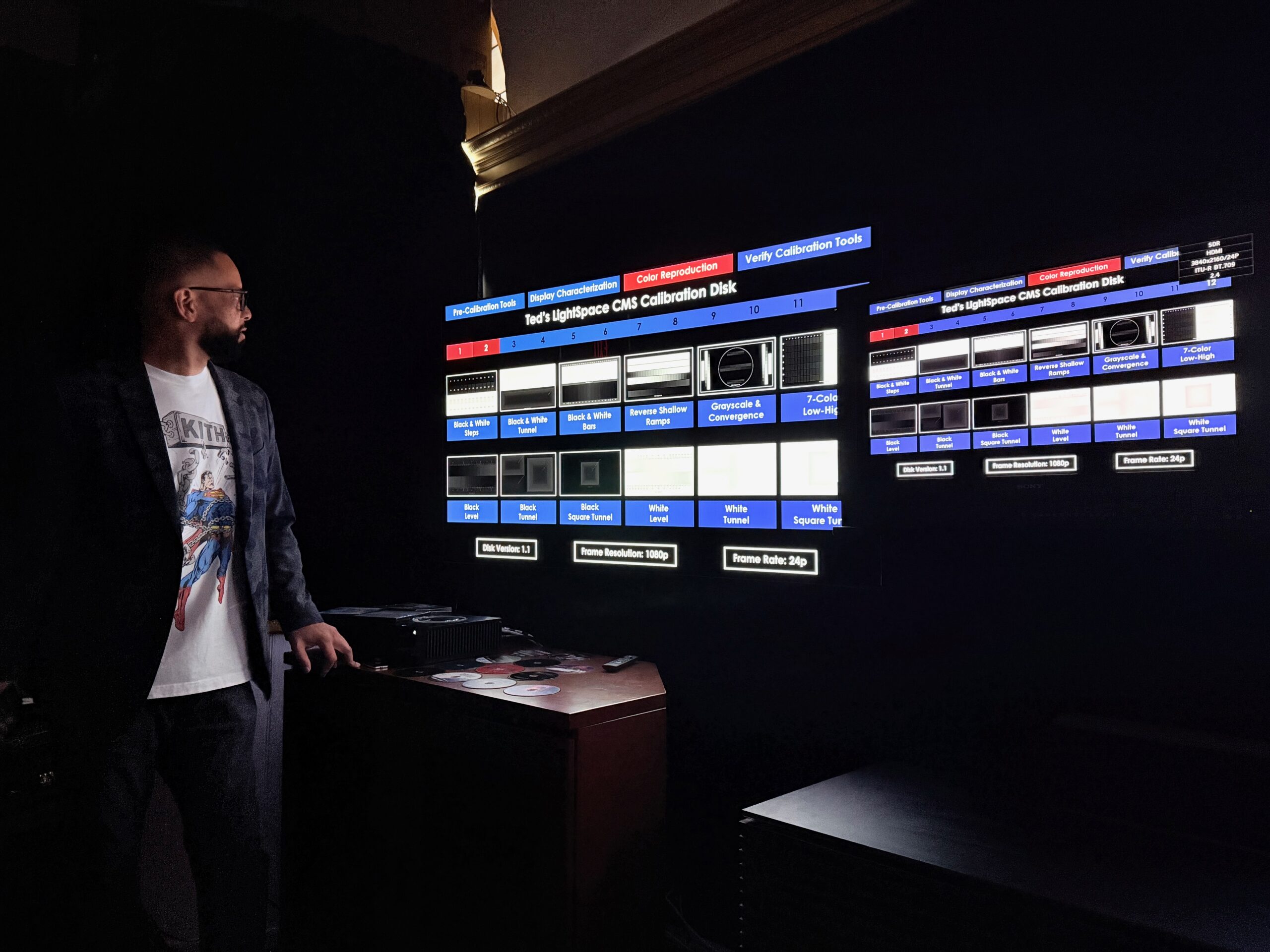 A person looking at a TV in a dark room.