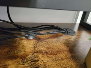 Several cord holders on floor under desk.