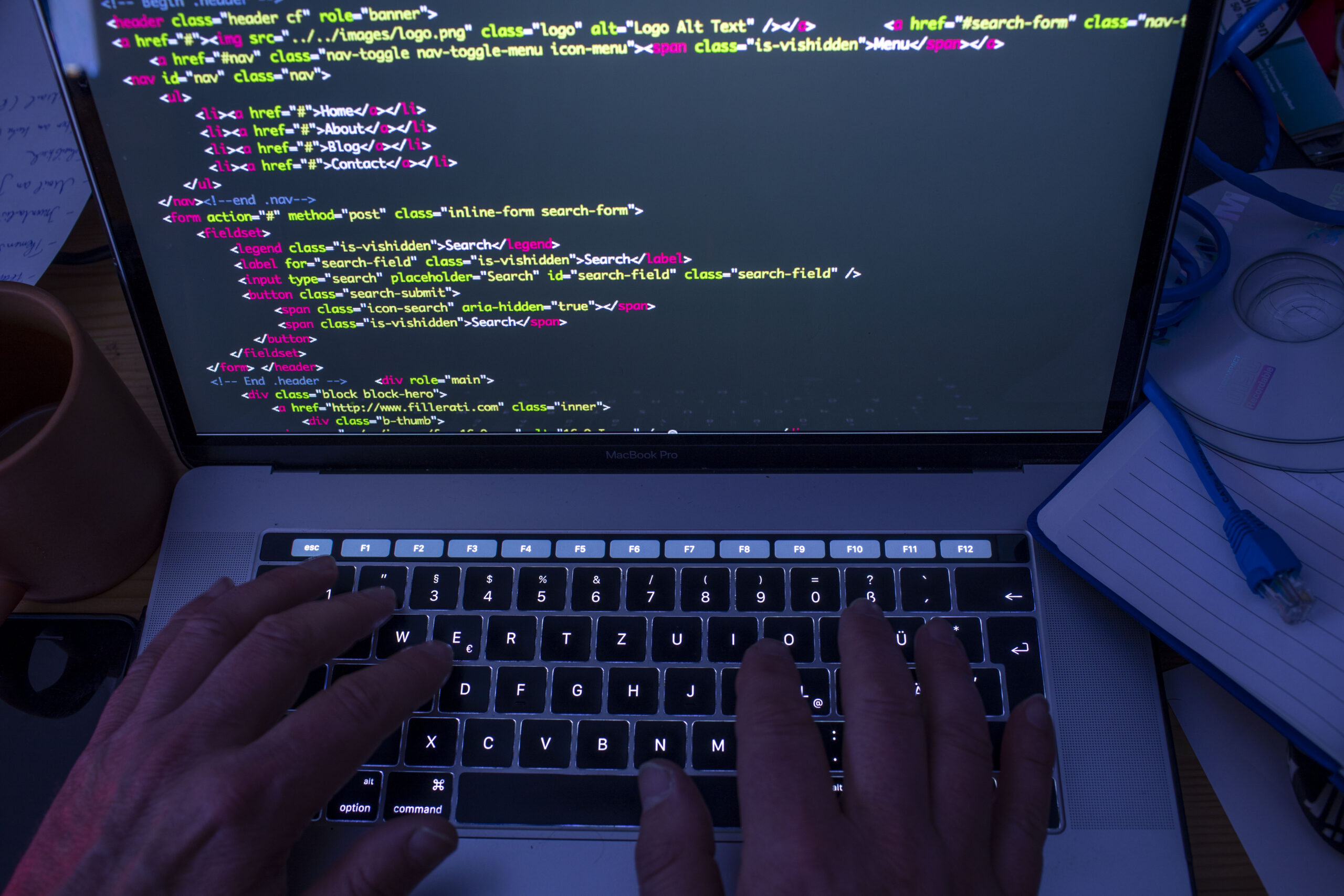 A photo of someone coding at a keyboard.
