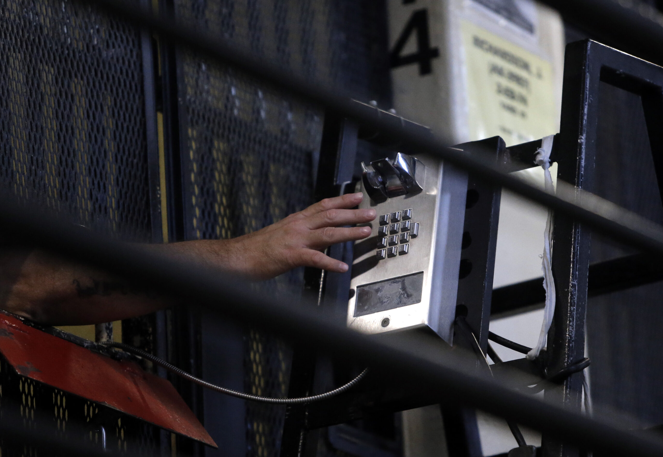 A photo of someone using a phone in jail
