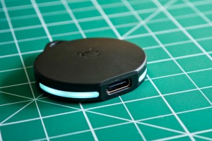 A Pebblebee Clip tracker with the light on