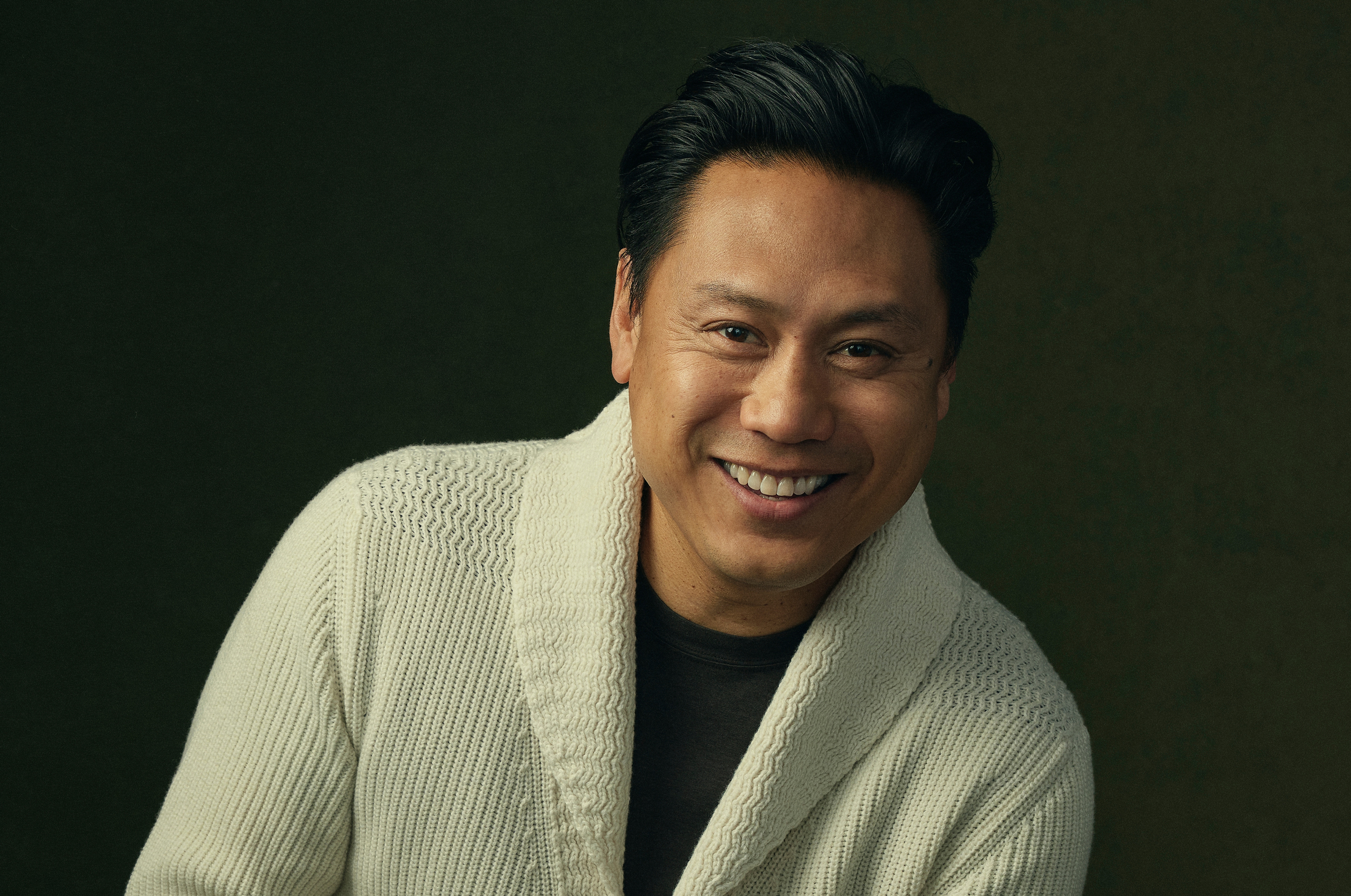 Director Jon M. Chu against a dark backdrop.