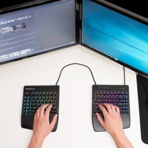 Two hands, each on a half of a split keyboard