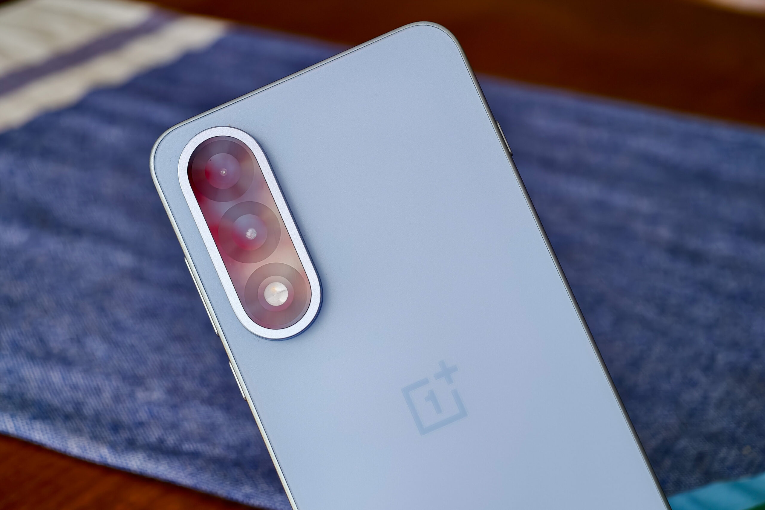 Photo of the OnePlus Nord 5 showing the cameras, with light refracting off the lenses.