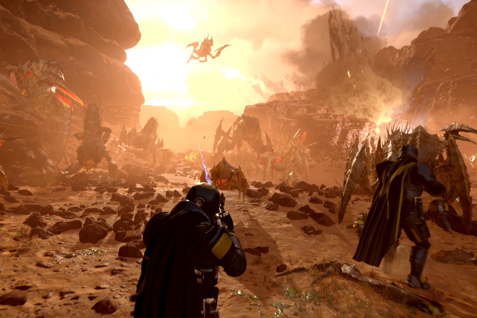 An image of Helldivers 2 showing players facing off against a swarm of bugs.