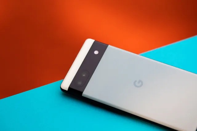 The back of a Pixel 6A phone against a blue and orange background.