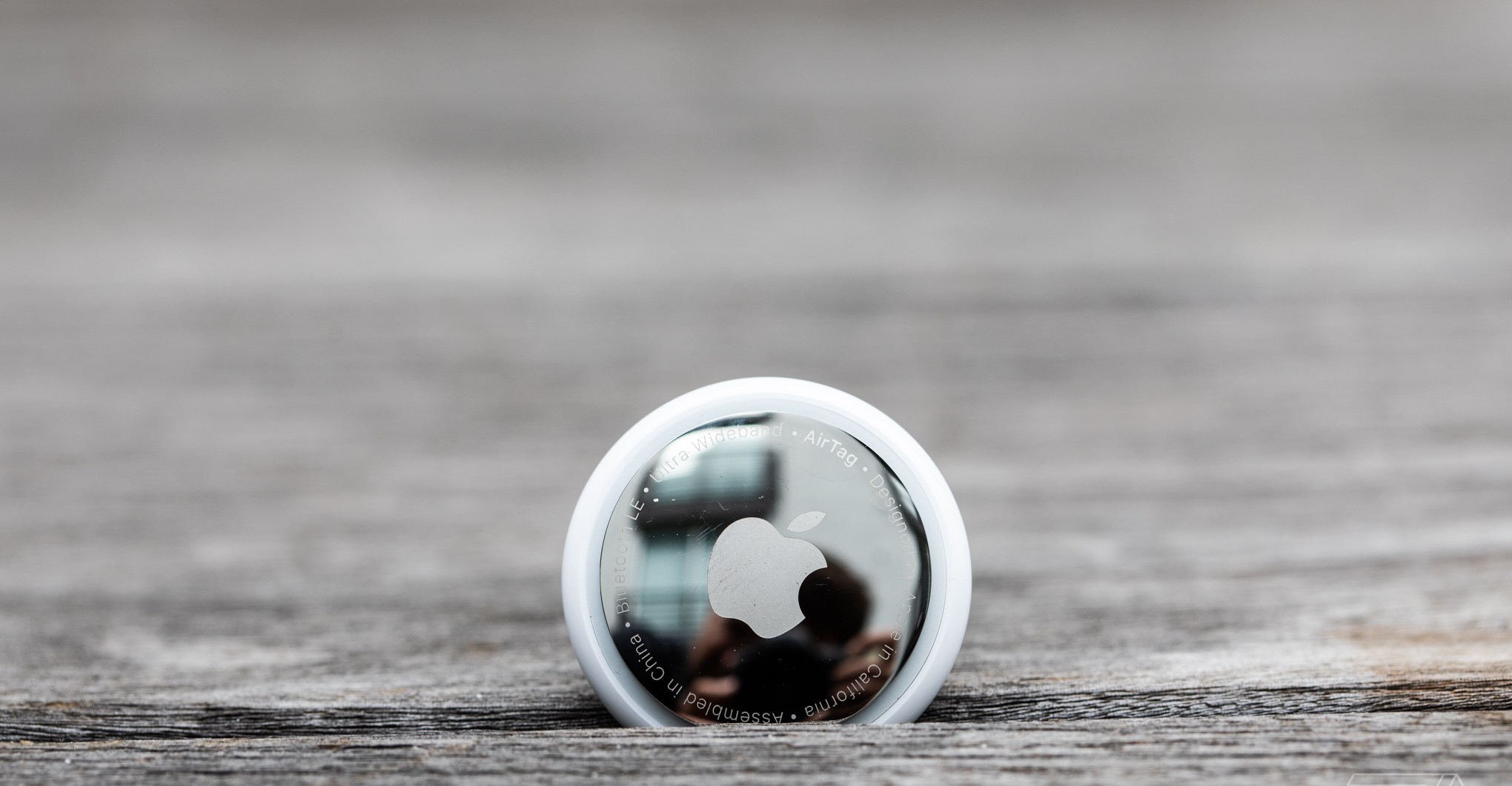 An AirTag wedged into some planks of wood.