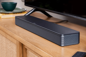 The Bose TV Speaker sitting on a media console.