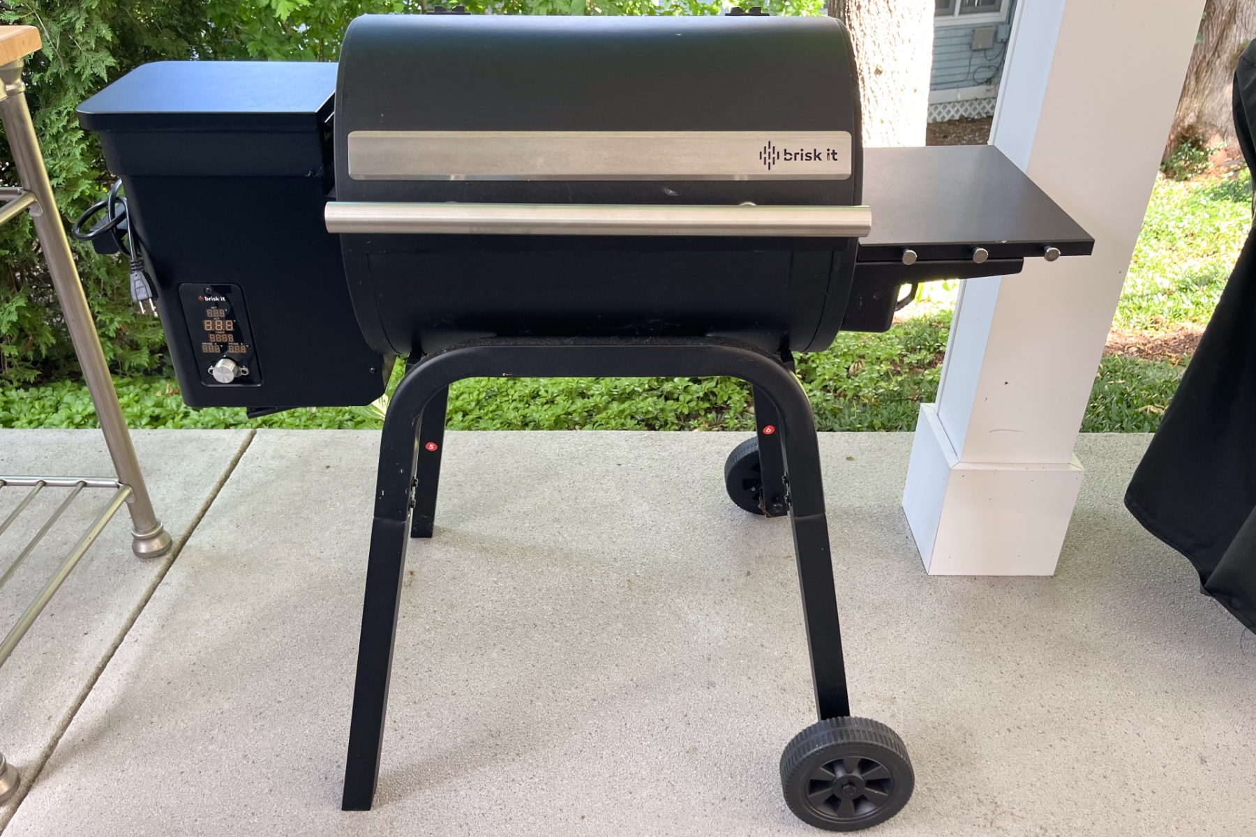 The Brisk It Zelos-450 smart electric pellet smoker on a patio.