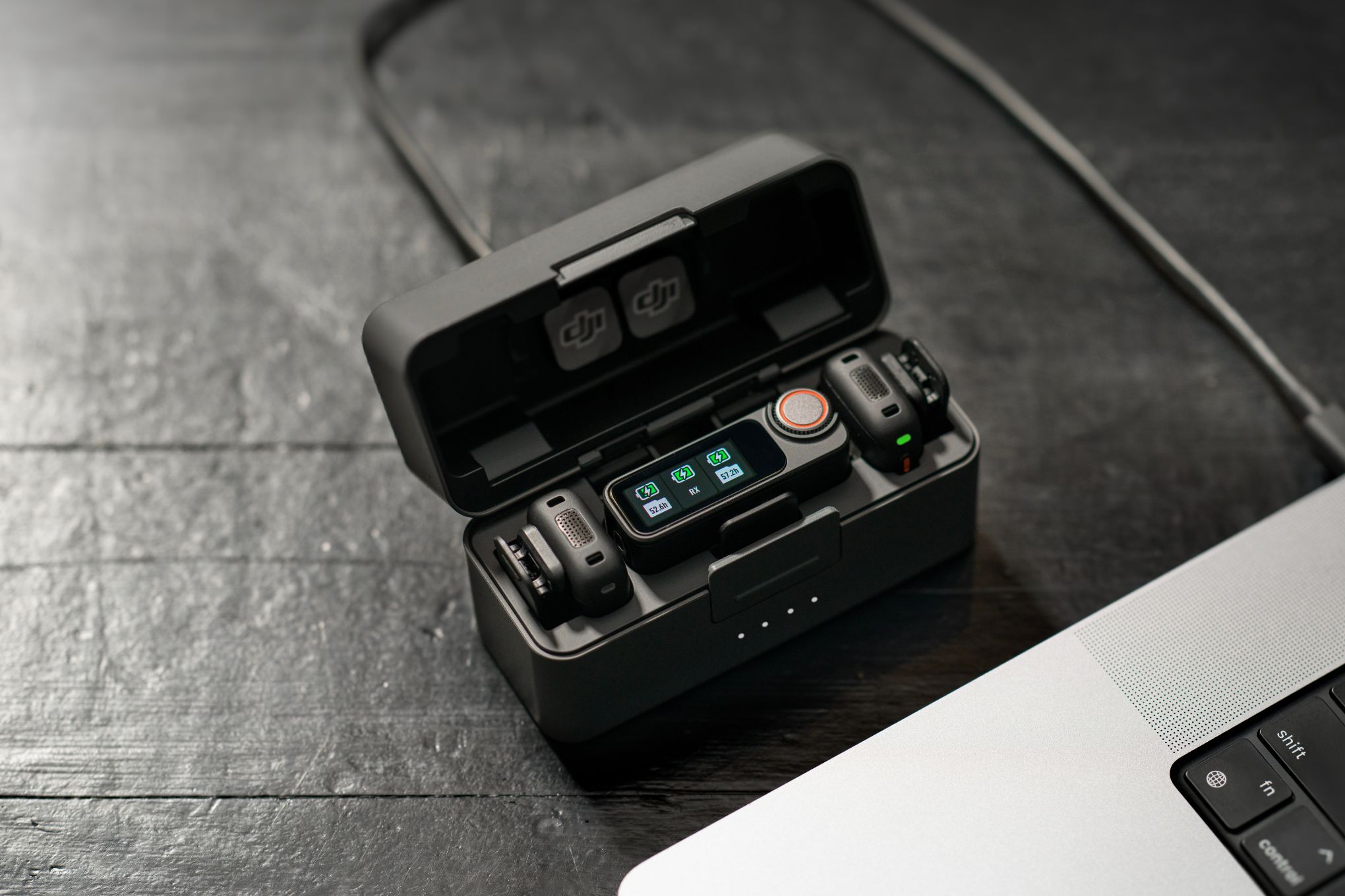 The DJI Mic 3 charging case with a transmitter and two receivers.