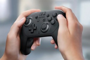 A close-up image of a pair of hands holding the Nintendo Switch 2 Pro Controller at a slight angle.