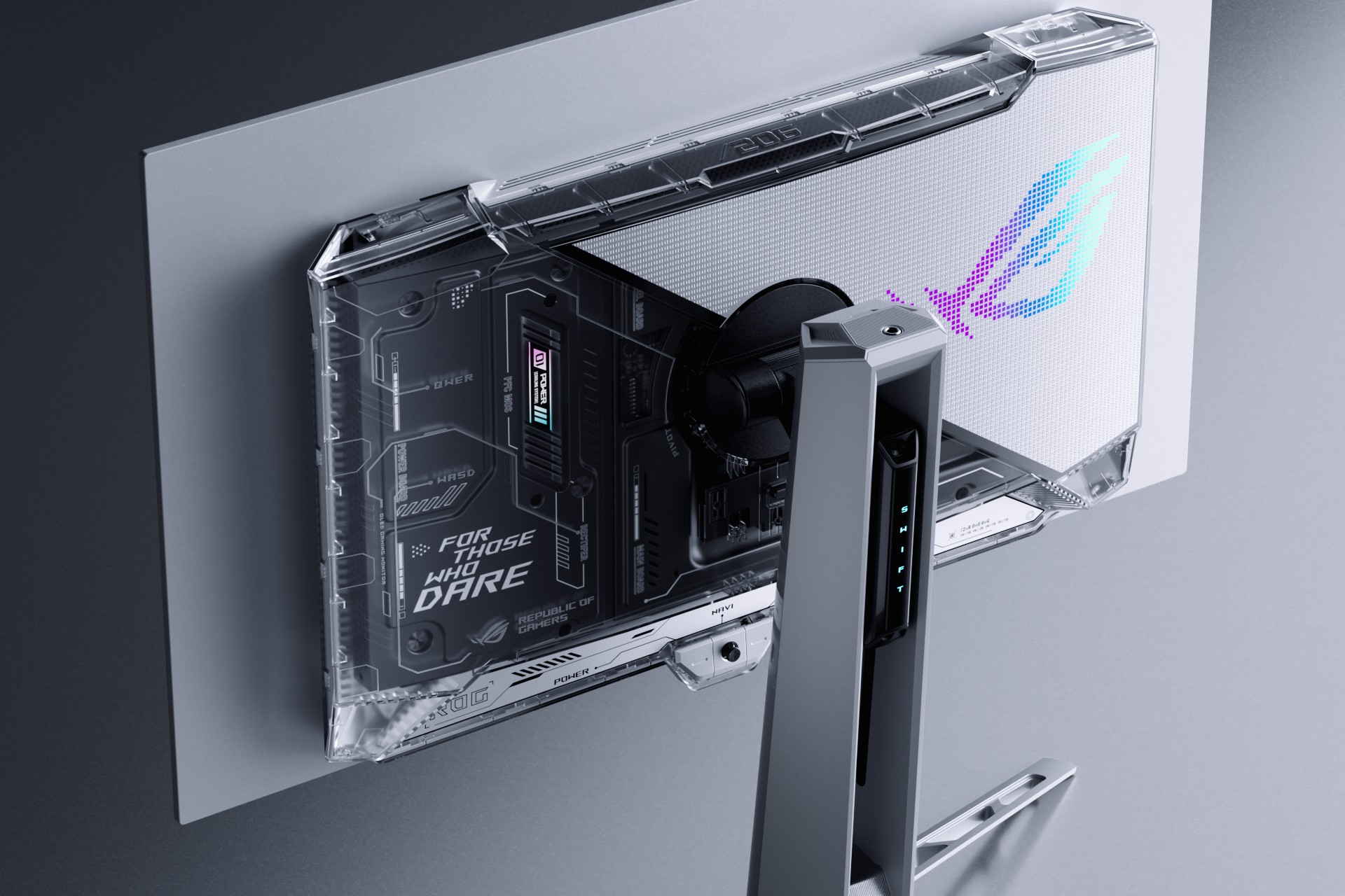 The unusually translucent back of a gaming monitor, looking rather cyberpunk with all its legends text and its sharp edges.