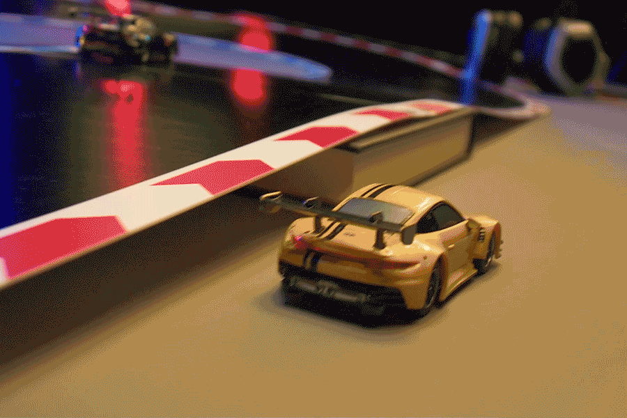 Several short video clips of cars racing around a Carrera Hybrid track. Several short video clips of cars racing around a Carrera Hybrid track.