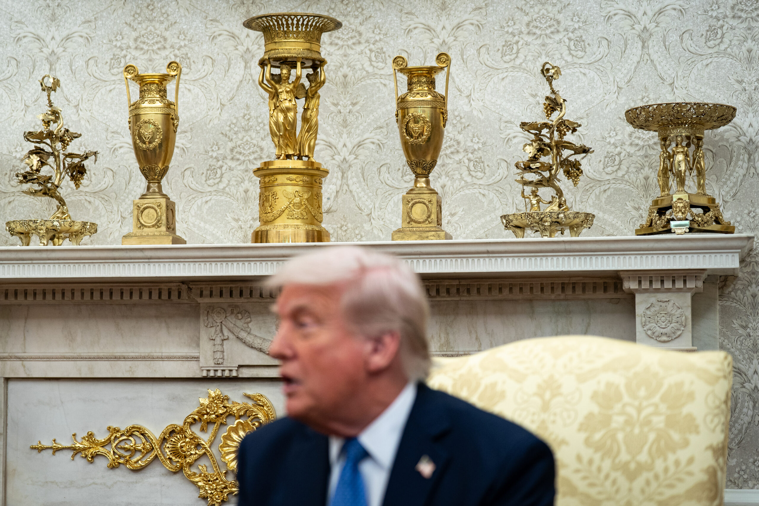 Gold decor on the mantle behind US President Donald Trump.
