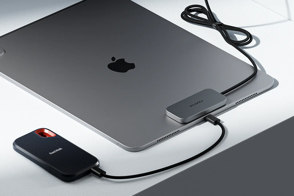The Kuxiu M30 magnetic charger attached to an iPad with an external drive attached to its USB-C port.