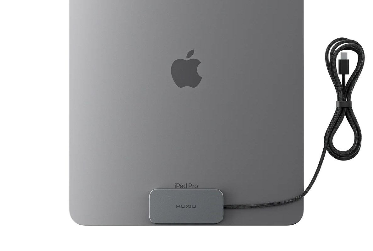 The Kuxui M30 magnetic charger attached to the back of an iPad.