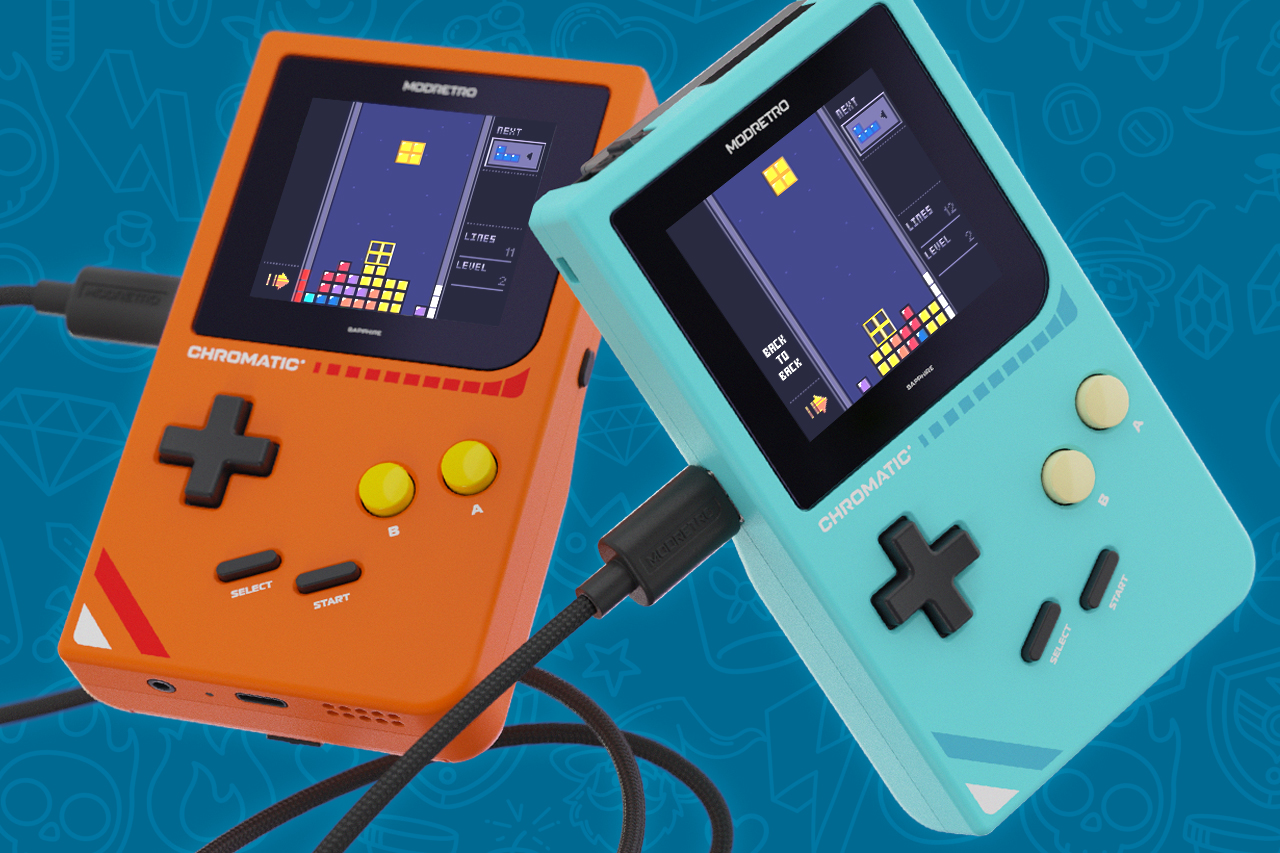 Two ModRetro Chromatic handhelds in orange and blue colors connected by a cable.