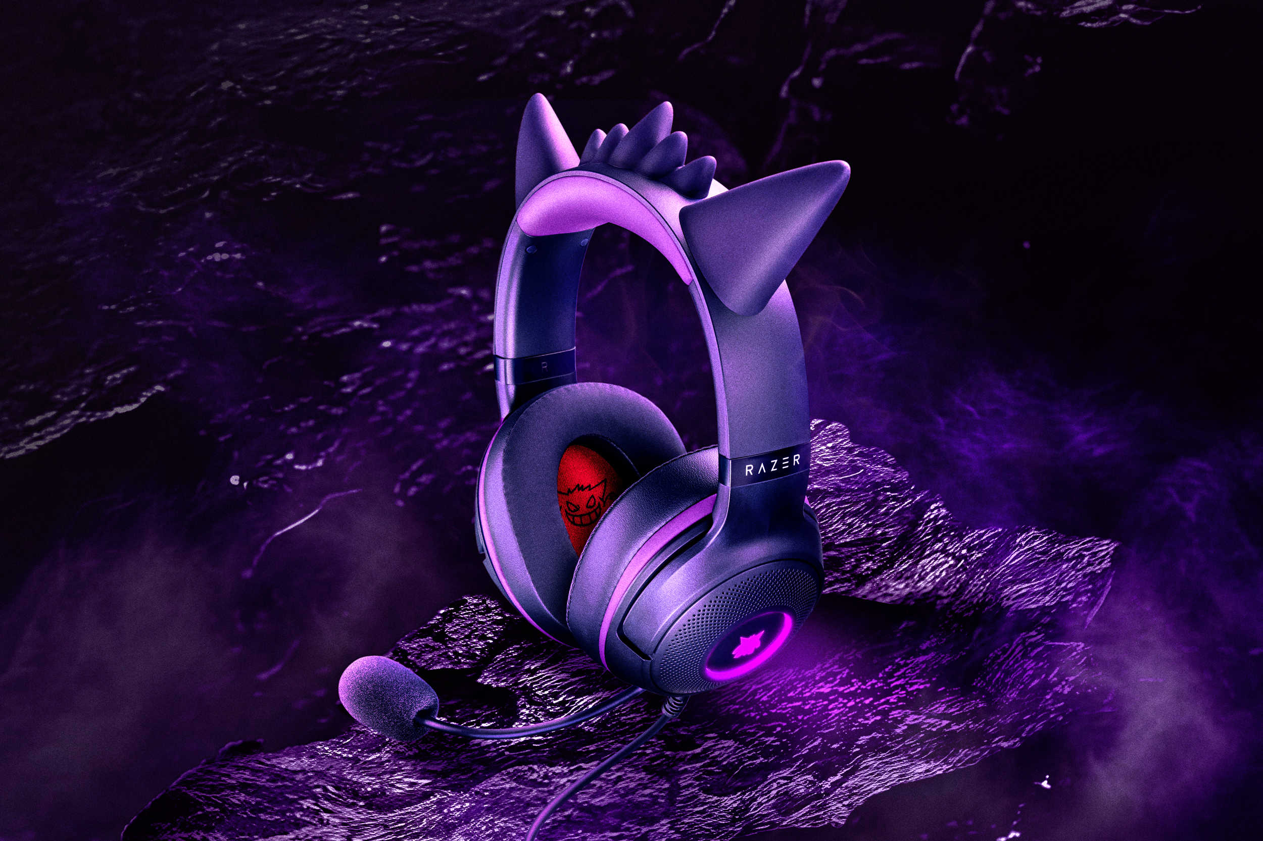 Razer’s Gengar Edition wired headphones sitting on atmospheric rocky terrain.