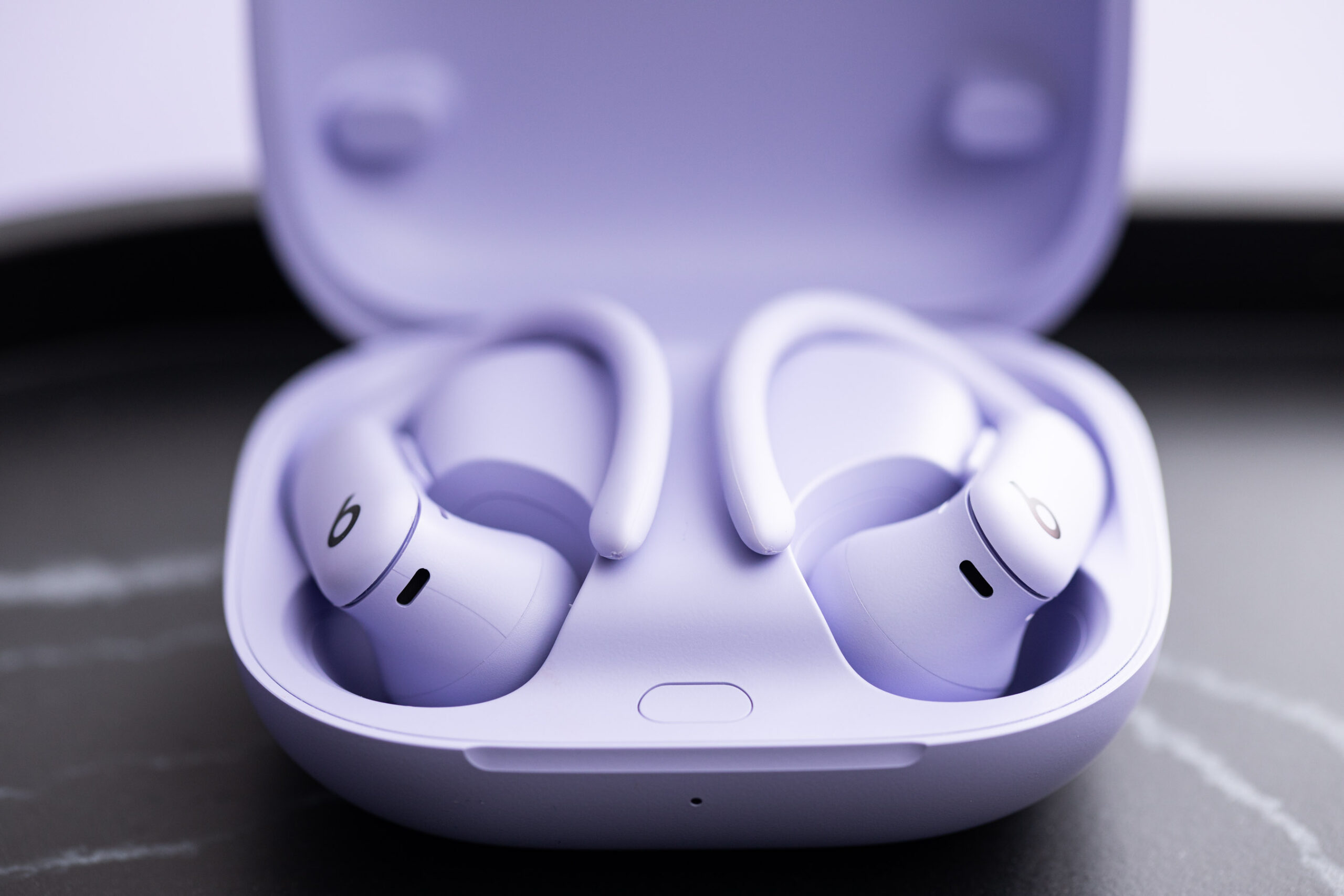 A close-up of the Powerbeats Pro 2 earbuds in their charging case.