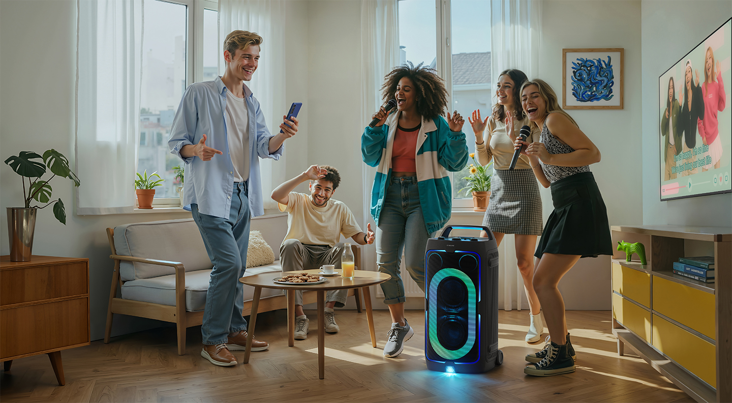 Photo of a group of people doing karaoke with a Samsung Sound Tower speaker. Photo of a group of people doing karaoke with a Samsung Sound Tower speaker.